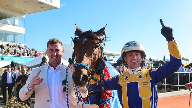 Swayzee's trainer Jason Grimson (left) and driver Cam Hart celebrate their champ's NZ Cup victory last year. Picture: HRNZ
