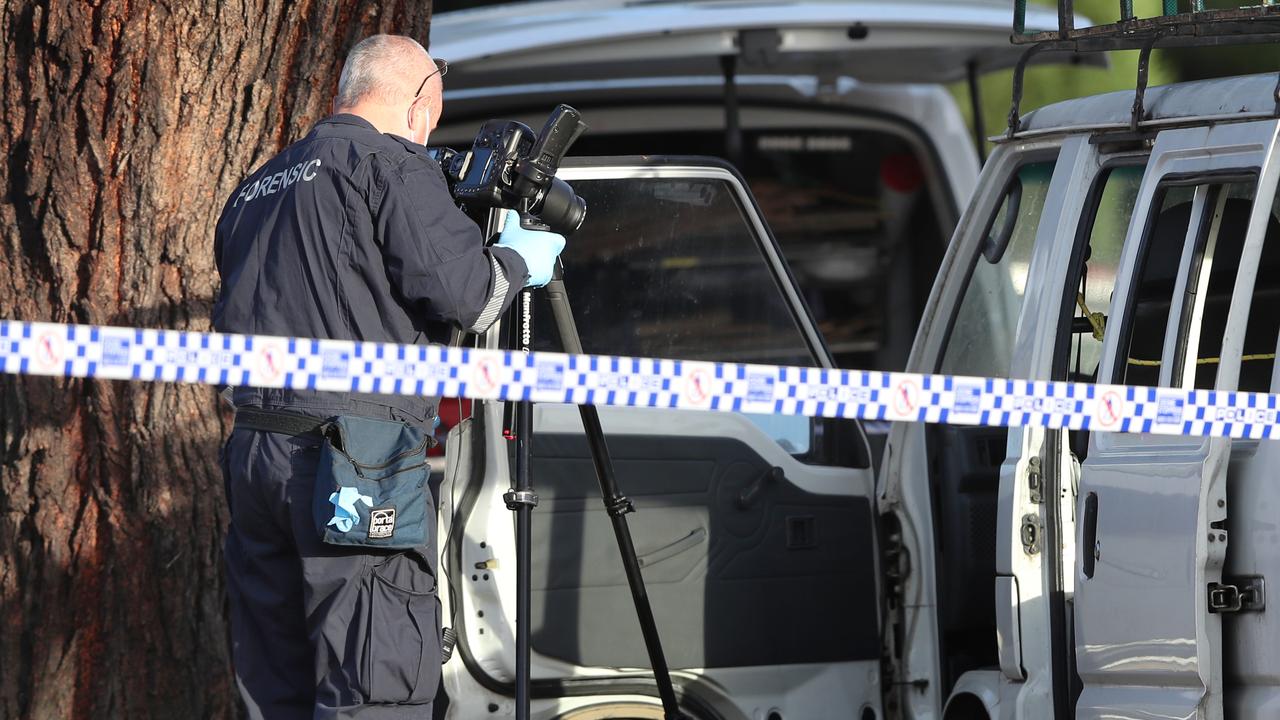 Forensics look inside a white van parked out front of a house in Scoresby. Picture: David Crosling