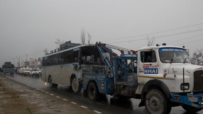 FILE- In this Feb. 14, 2019 file photo, a crane drags a partially damaged vehicle belonging to Indian paramilitary soldiers after an explosion in Pampore, Indian-controlled Kashmir. Pakistan's military spokesman tweeted that Indian aircraft crossed into Pakistan on Tuesday and carried out an airstrike but said there were no casualties from the attack. The incursion could have been in retaliation for the deadly Feb. 14 suicide bombing in India's half of Kashmir that killed at least 40 troops. The Pakistan-based militant group Jaish-e-Mohammad claimed responsibility. (AP Photo/Dar Yasin, File)