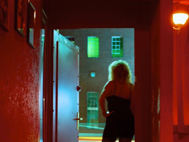 Prostitute Standing in Nightclub Doorway Looking Out