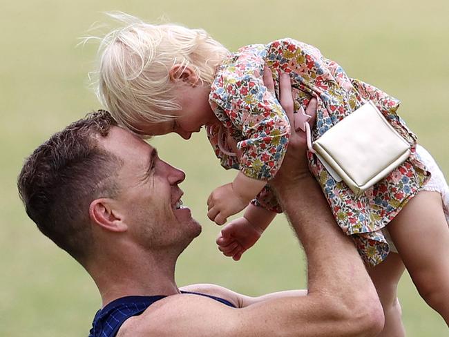 Joel Selwood with Tom Hawkins’ daughter Primrose. Picture: Michael Klein