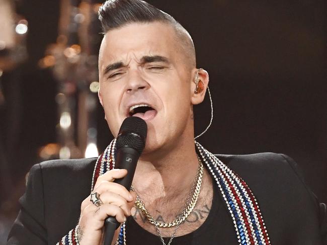 British singer Robbie Williams performs during the "Ein Herz fuer Kinder" (A Heart for Children) charity gala in Berlin on December 7, 2019. (Photo by Jens Meyer / POOL / AFP)