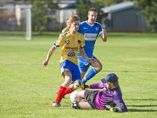 HARD PASS: Rockville keeper Hayden Chalmers saves at the feet of USQ attacker Cormac McCarthy. Chalmers shone for Rovers in their 2-1 FFA Cup loss to USQ at the weekend. Picture: Nev Madsen