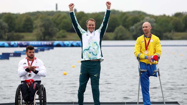 Silver medallist David Phillipson of Great Britain, gold medallist Curtis McGrath of Australia, and bronze medallist Mykola Syniuk of Ukraine celebrate on the podium during the KL2 200m medal ceremony at Vaires-Sur-Marne Nautical Stadium. Picture: Steph Chambers/Getty Images