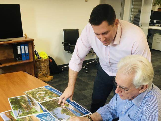 Scott Waters (Darwin Council CEO) and Kon Vatskalis (Darwin Lord Mayor) look over artists impressions of the planned redevelopment of Casuarina pool. Picture Gary Shipway