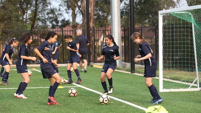 Players get to work on an all-weather synthetic sports field which opened in Fairfield, Sydney last year. Ipswich’s first synthetic soccer pitch is being built at Ipswich State High School.