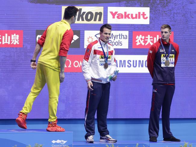 China's Sun Yang, left,yells at Duncan Scott (R) as Russia's Martin Malyutin looks on during the medal ceremony for the men's 200m freestyle final. Picture: AP Photo/Mark Schiefelbein