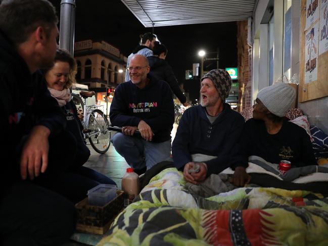 Newtopian Outreachers Lee Coleman, Sue Byrne and Jim Lowe talking with Scott and partner Roslyn on King St in Newtown. Picture: Jonathan Ng