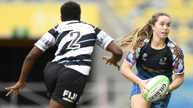 Tia Hinds up against a Fijian rival at the recent Oceania Sevens Challenge match in Townsville.