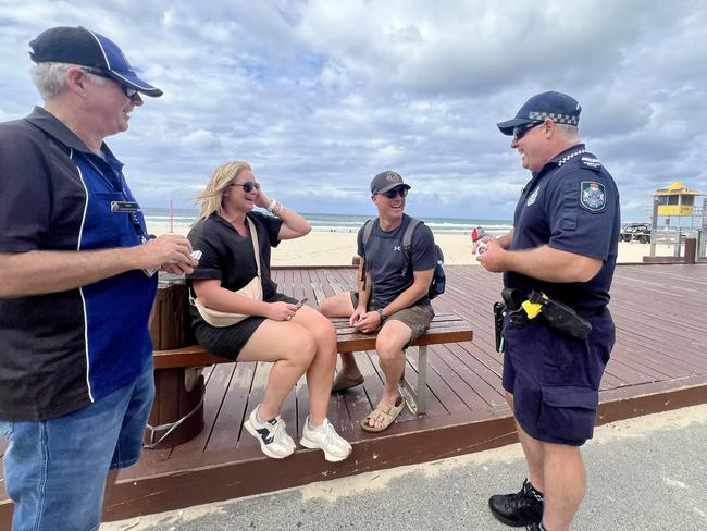 Volunteer in Policing Andy Peters and Senior Constable Dion Bryant chat with Marita and Chris Pattison from Melbourne, who were visiting the Gold Coast to celebrate their 25th wedding anniversary. Picture: Keith Woods.