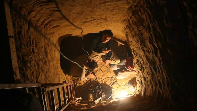 Palestinian officers are seen inside a smuggling tunnel during an operation to seal it in Rafah, in the southern Gaza Strip in 2007.