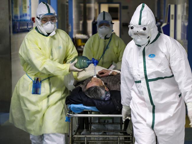 Medical workers transfer a patient in the isolation ward for 2019-nCoV patients at a hospital in Wuhan in central China's Hubei province. Picture: AP