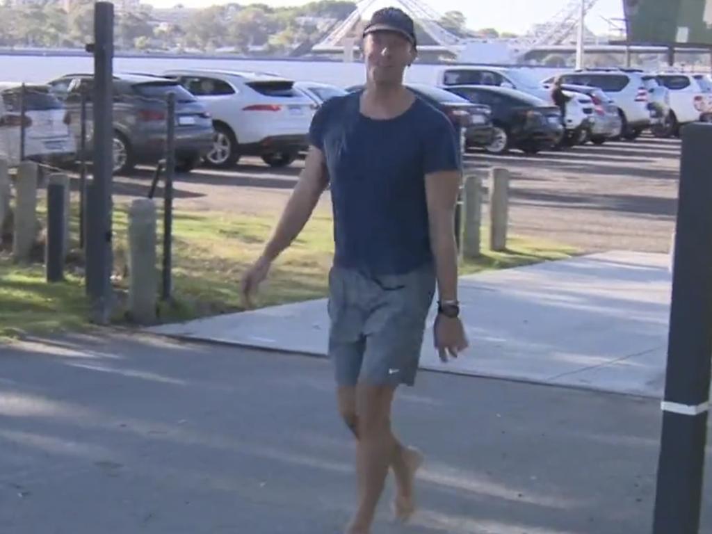 Chris Martin ducks out of his Perth hotel sans shoes.