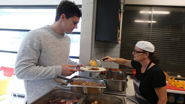 Scott Thompson gets some eggs for breakfast from club chef Gail Miller. Pic: Michael Klein