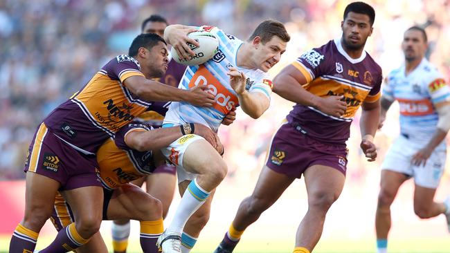 Jacks tries to bust through the tackle of Anthony Milford during the Titans’ upset win over the Broncos. Picture: Jono Searle/Getty Images