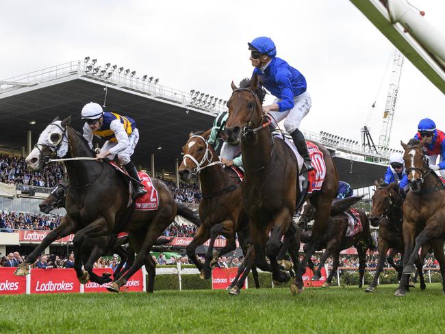 MELBOURNE, AUSTRALIA - OCTOBER 22: James McDonald riding Anamoe defeating Mark Zahra riding I'm Thunderstruck and Damien Oliver riding El Bodegon in Race 9, the Ladbrokes Cox Plate,  during Cox Plate Day at Moonee Valley Racecourse on October 22, 2022 in Melbourne, Australia. (Photo by Vince Caligiuri/Getty Images)