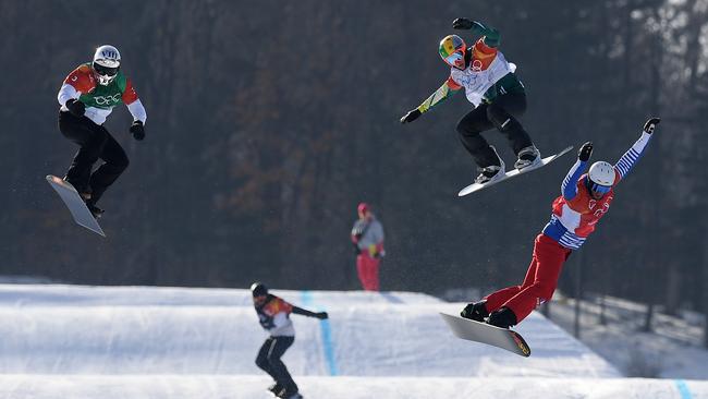 Australia’s Jarryd Hughes, second from right, clears the last jump behind gold medallist Pierre Vaultier, right, in the snowboard cross final. Picture: AAP