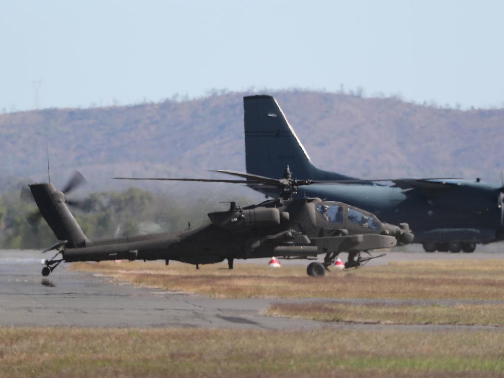 An American Apache prepares to take off over Rockhampton. Australian and American troops on the ground at Camp Rockhampton. Pic Peter Wallis