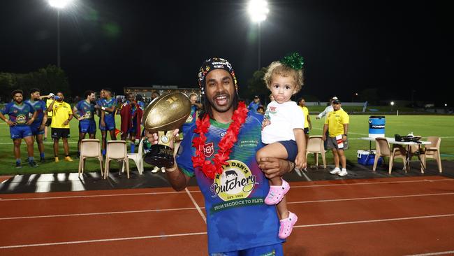 Innisfail Leprechauns' Jarred Laza cuddles his daughter Ellara Laza, 1, after winning Player of the Final. Picture: Brendan Radke