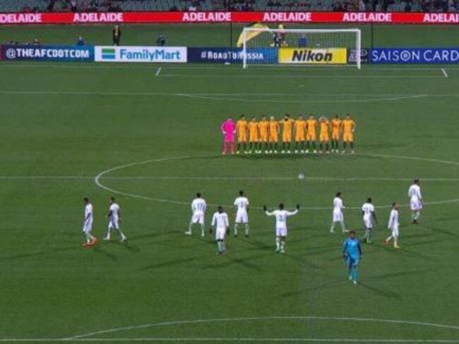 The Saudi players moved to their positions and continued to warm up.