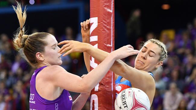 Tara Hinchliffe of the Firebirds and Sophie Garbin of the Swifts collide with the goalpost.