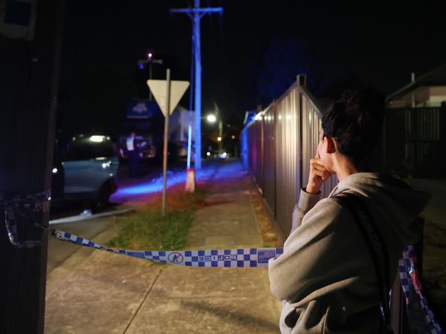 Neighbours watch on as investigators arrive. Picture: Brendan Beckett