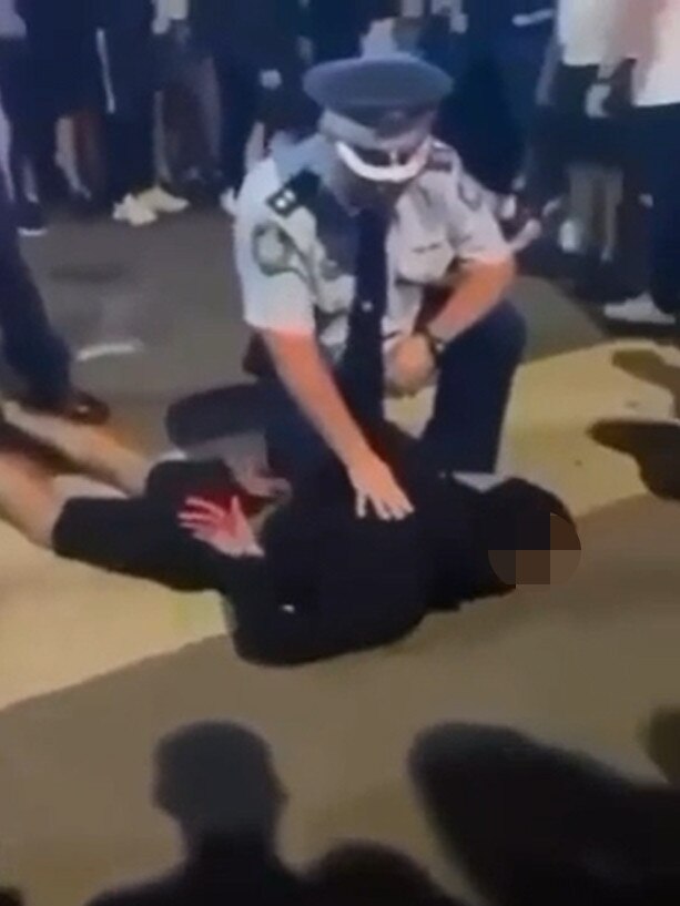 A police officer arrests youth at the scene.