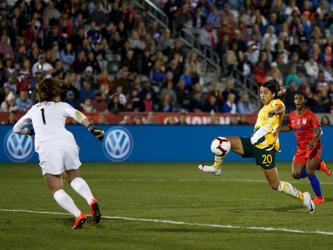 COMMERCE CITY, CO - APRIL 4: Sam Kerr #20 of Australia splits the defense and takes a shot as Alyssa Naeher #1, Crystal Dunn #19 and Becky Sauerbrunn #4 of the United States defend during the first half at Dick's Sporting Goods Park on April 4, 2019 in Commerce City, Colorado.   Justin Edmonds/Getty Images/AFP == FOR NEWSPAPERS, INTERNET, TELCOS & TELEVISION USE ONLY ==