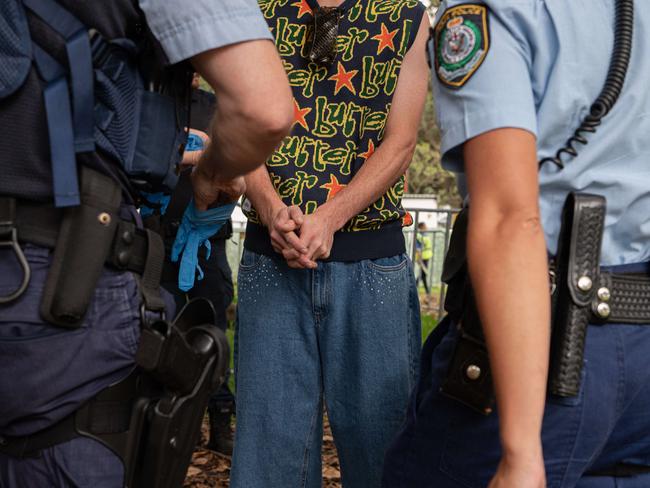 SYDNEY, AUSTRALIA - NewsWire Photos , JANUARY 01, 2024: A man is being detained by police are at the Field Day Music festival in Sydney. Picture: NCA NewsWire / Flavio Brancaleone