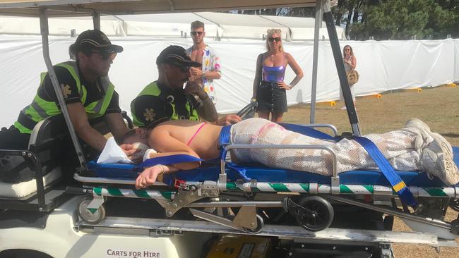 A paramedic team help a girl at the Electric Garden festival.