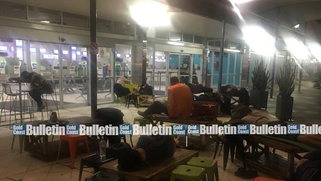 Stranded Tigerair travellers sleep outside Gold Coast Airport terminal overnight on December 29 after an official kicked them out while the airport shut from 10.30pm to 4.30am. Photo: Jay Gadhavi