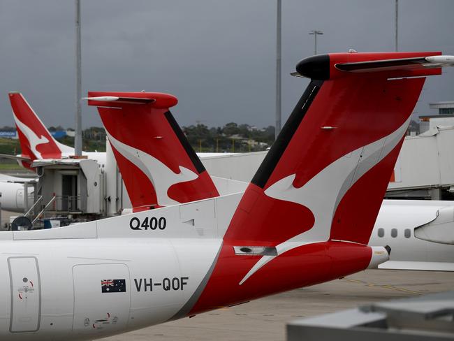 SYDNEY, AUSTRALIA - NCA NewsWire Photos DECEMBER, 31, 2020: The tails of grounded Qantas planes are seen on the tarmac at Sydney Domestic Airport. Victoria has announced a hard border closure with NSW from 11:59pm on January 1, whilst SA will reimpose its hard border closure with NSW from midnight January 1, following 10 new COVID-19 cases in NSW today. Picture: NCA NewsWire/Bianca De Marchi