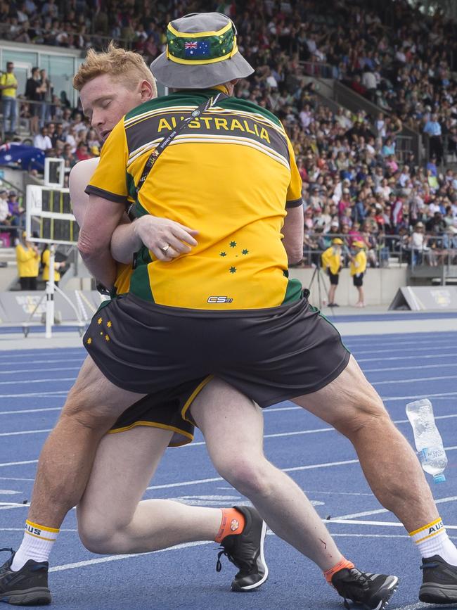 Jesse Costelloe of Australia stumbles after crossing the finish line during the Mens 1500m IT7 final. Picture: AAP/Craig Golding