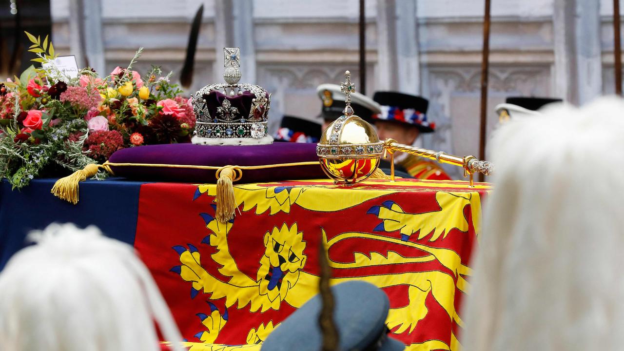 The coffin of Queen Elizabeth II, draped in the Royal Standard with the Imperial State Crown and the Sovereign's orb and sceptre.