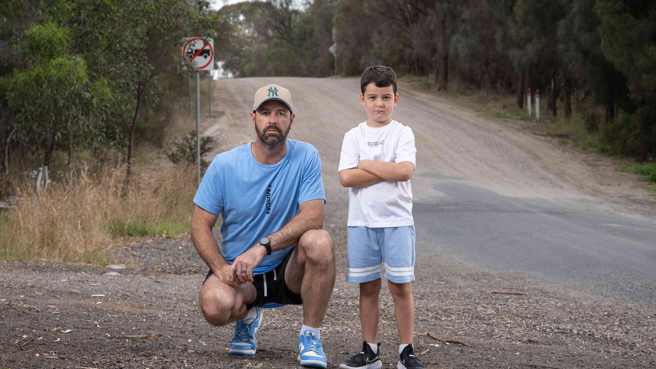 Wade Veldhuis, pictured with son Bohdi, says Williams Rd in Mt Duneed is in desperate need of an upgrade. Picture: Brad Fleet.