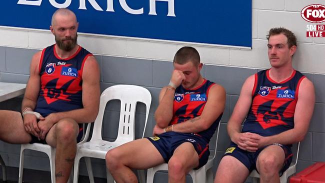 Demons players look dejected after their 39-point loss to Essendon.