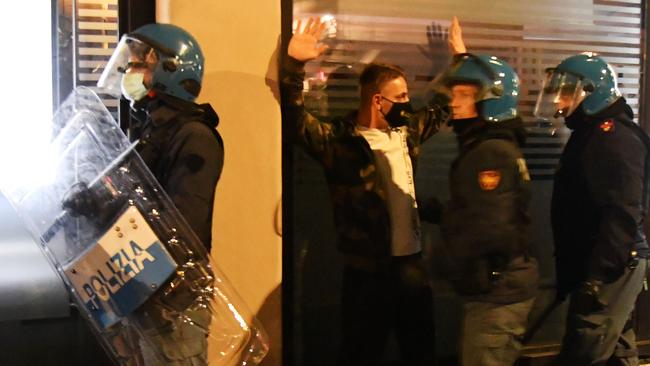 Police arrest an extreme far right Forza Nuova party activist during a protest against Covid restrictions in Rome on Sunday. Picture: AFP