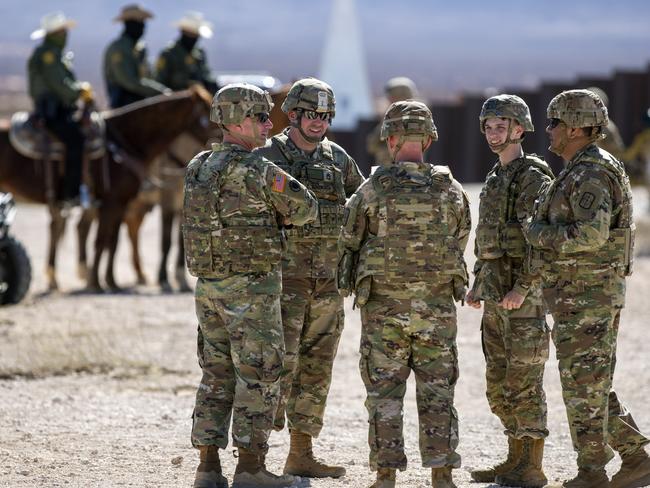 Army soldiers chat while waiting the arrival of Defense Secretary Pete Hegseth to the US-Mexico border. Picture: AP Photo/Andres Leighton