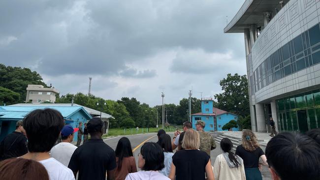 Travis King, fourth left in a black shirt, takes a border tour to the truce village of Panmunjom in the DMZ on July 18. Picture: AFP