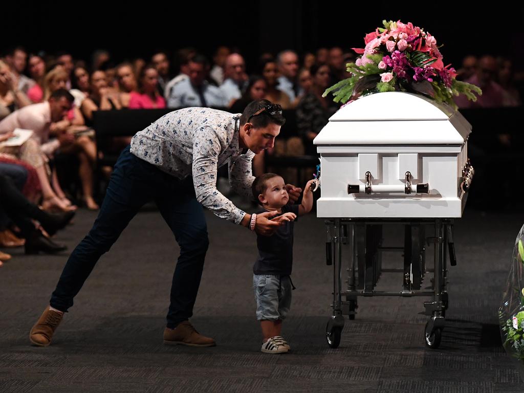 Hannah Clarke's brother Nat holds his son Tyler as he reaches for the coffin during the funeral for Hannah and her three children Aaliyah, Laianah and Trey in Brisbane. Picture: Dan Peled/AAP