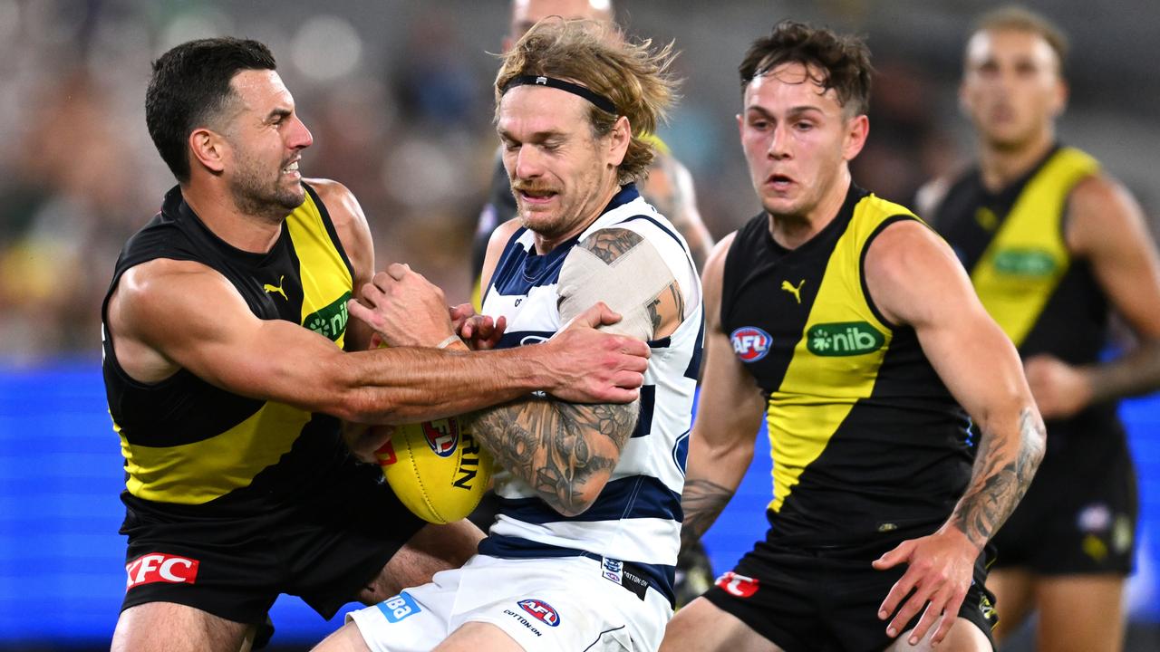 MELBOURNE, AUSTRALIA - MAY 12: Tom Stewart of the Cats is tackled by Jack Graham of the Tigers during the round nine AFL match between Richmond Tigers and Geelong Cats at Melbourne Cricket Ground, on May 12, 2023, in Melbourne, Australia. (Photo by Quinn Rooney/Getty Images)