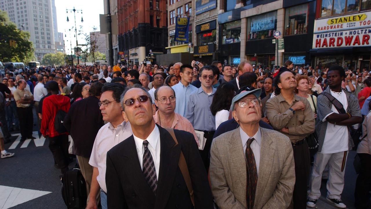 People below look up as the World Trade Centre goes up in flames on September 11, 2001 in New York City. Picture: Spencer Platt/Getty Images