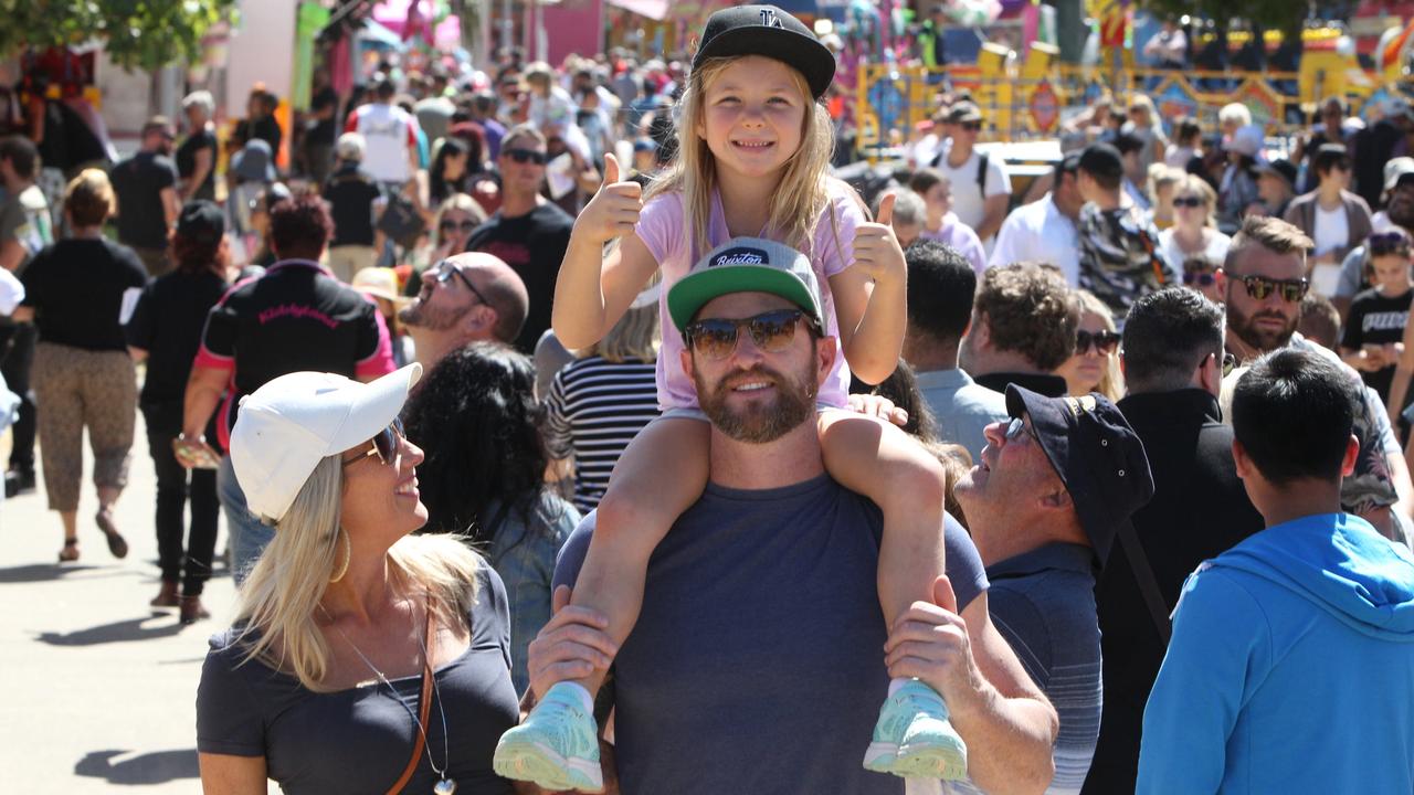 Mia Cannon, 6, gets a better view from dad Simon Cannon’s shoulders while mum April Cannon looks on. Picture: Mike Batterham