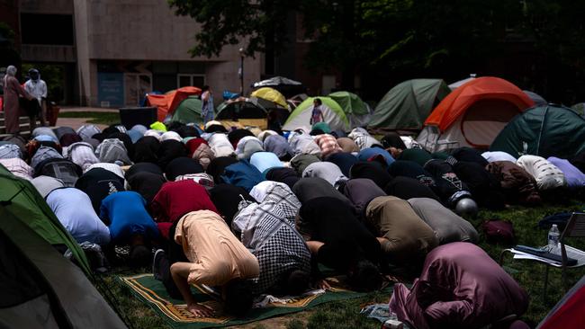 People pray at an encampment at University Yard at George Washington University.