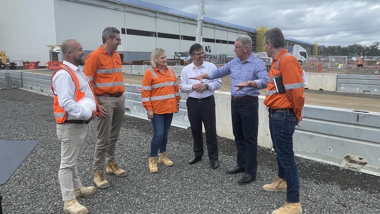 Manufacturing Minister Dale Last and Maryborough MP John Barounis talk to members of Downer at the Torbanlea train manufacturing factory, set to be complete in late 2026.