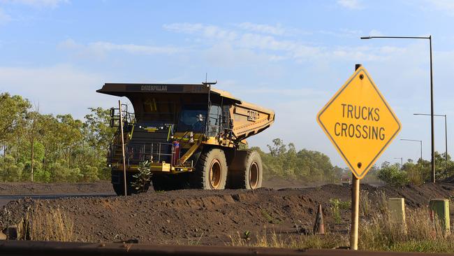 A haul truck drives past a crossing at South32's GEMCO manganese mining operation on Groote Eylandt.