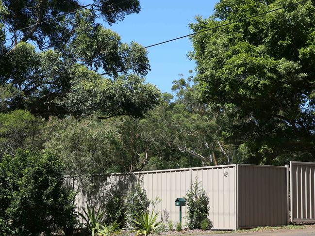 Millionaire Tony Denny's Colorbond fence outside his home at Killcare Heights. Picture: AAP /Sue Graham.