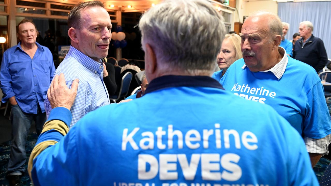 A Liberal supporter speaks to Tony Abbott, who also lost the election three years ago to Zali Steggall. Picture: Jeremy Piper