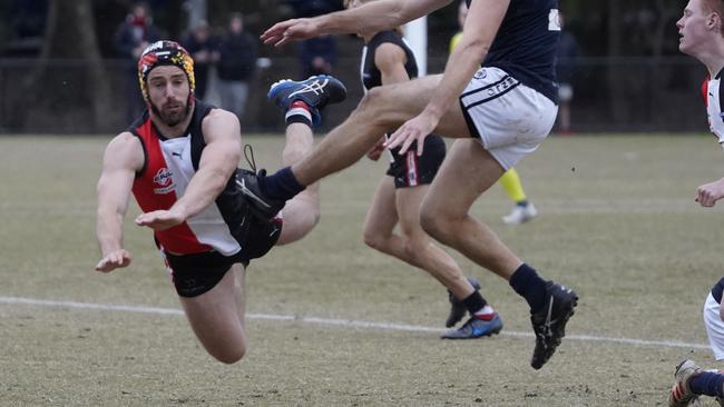 Michael Locco (left) flies for the smother. Picture: Valeriu Campan