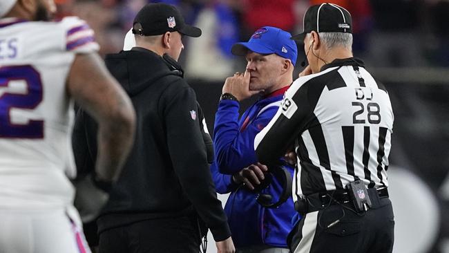 Head coach Sean McDermott of the Buffalo Bills and head coach Zac Taylor of the Cincinnati Bengals speak during the suspension of their game following the injury of Damar Hamlin. (Photo by Dylan Buell/Getty Images)